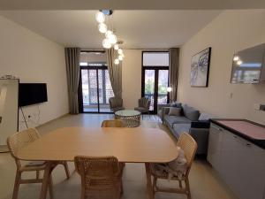 a living room with a table and a couch at Apartment, Muscat Bay in Muscat