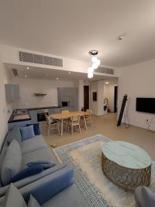 a living room with a couch and a table at Apartment, Muscat Bay in Muscat