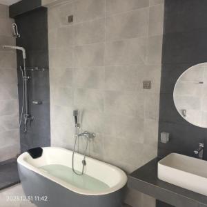 un bagno con vasca, lavandino e specchio di Luxe Diamond Villa a Matara Altre 53 foto