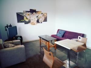 a living room with a couch and a table at Residence Jardin Tropical in Yaoundé