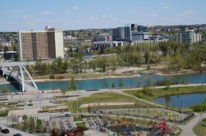 a view of a city with a river and buildings at 1 Bedroom with Balcony in Calgary