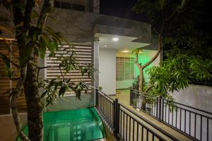a house with a swimming pool at night at Anu - The Breeze of Heaven in Kandy