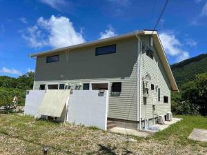 a house with a garage at 米原ビーチステイLUANA in Fukai