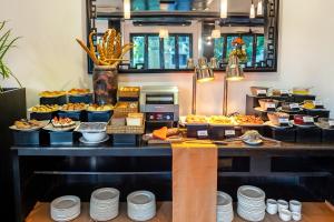 a buffet line with many different types of food at HOI AN HISTORIC HOTEL in Hoi An