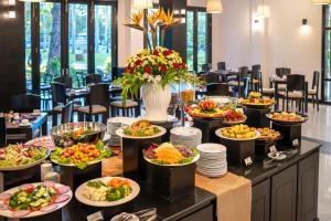 a buffet with many plates of food on a table at HOI AN HISTORIC HOTEL in Hoi An