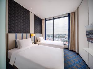 Holiday Inn Express Singapore Katong by IHG客房内的一张或多张床位