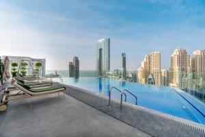 a swimming pool on the roof of a building at Livbnb -Glam Studio in Marina, Next to Marina Walk in Dubai
