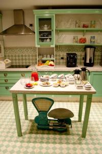 a kitchen with a table with food on it at Hotel Boutique Le Reve in Santiago