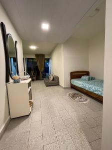 a bedroom with a bed and a tiled floor at Chalet en urbanisazion de Solemar, piscinas, tennis, futbol, Balon cesto in Al Kaslīk