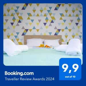 a bedroom with a bed with white pillows at Petite palace in Rethymno Town