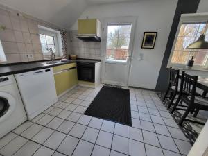 a kitchen with a sink and a dishwasher at Nörderland in Norden +9 photos