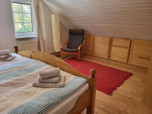 a room with two beds and a chair in it at Nörderland in Norden