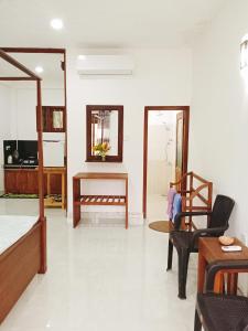 a living room with a bed and a table and chairs at New Summer Vacation in Hikkaduwa