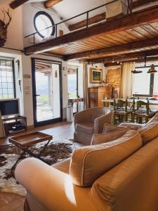 a living room with a couch and chairs and a table at Azienda Agricola Pietra Pizzuta in Torre deʼ Passeri