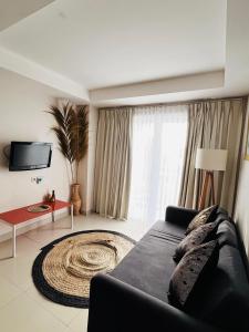uma sala de estar com um sofá e uma grande janela em Kuta View Apartment with 2 BR in Kuta Bali em Kuta