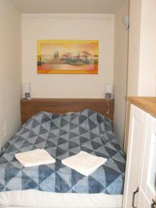 Posteľ alebo postele v izbe v ubytovaní Ezüsthíd Apartman