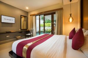 a bedroom with a bed and a desk and a window at Samaja Villas Seminyak in Seminyak