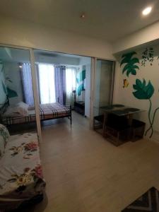 a room with a bedroom with a bed and a desk at SM Bicutan Condominium in Manila