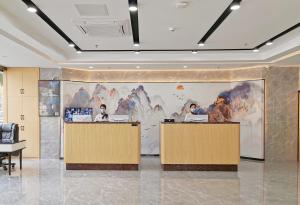 a lobby with a large painting on the wall at Connar Hotel - Shenzhen Futian in Shenzhen