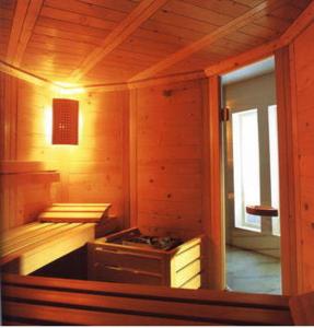 a kitchen with a stove in a wooden cabin at Hotel Edelweiss in Innsbruck