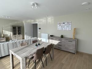 a living room with a table and a couch at Residentie Sluispark in Ghent