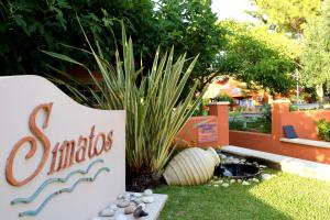 a sign for a santa ana sign in a garden at Simatos αpARTments & Studios in Lassi