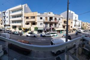 a view of a city street with cars and buildings at Modern 3BR Apartment in Swieqi in Is-Swieqi