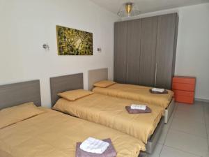 a room with two beds with towels on them at Modern 3BR Apartment in Swieqi in Is-Swieqi