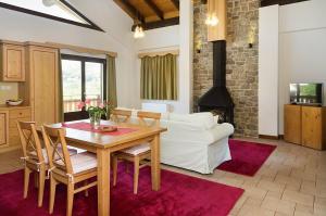 a living room with a table and a white couch at Alpine Aria in Kalavrita