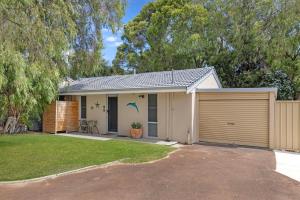 a house with a garage and a fence at Broadwater Bay Villa in Broadwater