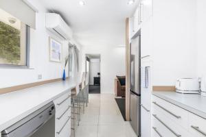 a kitchen with white cabinets and a counter top at Broadwater Bay Villa in Broadwater