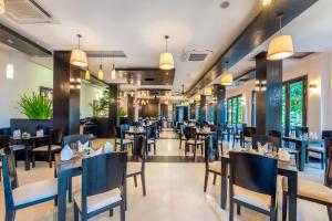 a dining room with tables and chairs in a restaurant at HOI AN HISTORIC HOTEL in Hoi An