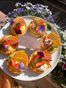 een bord gebak met fruit en bloemen erop bij Hotel Berg in Stuttgart