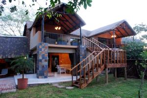 a house with a staircase in front of it at Tau @ Kruger in Marloth Park