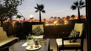 a patio with a table and chairs and a view of a city at Prestigia,Golf, piscine, soleil, paysage, sport, spacieux,lux résidence in Marrakesh