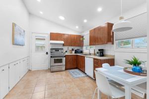 a kitchen with wooden cabinets and a table with a white table sidx sidx at Beautiful and quiet urban cabin in Montreal