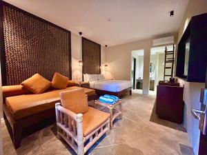 a hotel room with a bed and a couch at The Henry Resort Boracay in Boracay