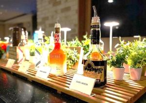 two bottles of alcohol on a table with potted plants at Super Hotel Namba Nipponbashi in Osaka