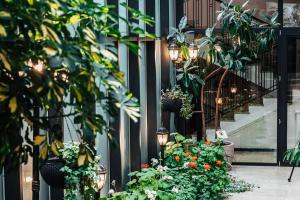 a building with plants and lights and flowers at Tbilisi Laerton Hotel in Tbilisi City