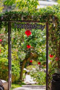 a sign for a garden with flowers on it at Wine Valley Homestay Dalat in Xuan An