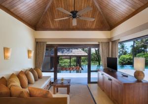- un salon avec un canapé et un ventilateur de plafond dans l'établissement Sheraton Hua Hin Pranburi Villas, à Pran Buri