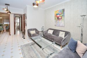 a living room with a couch and a table at Cozy 2 BR Gauthier Oasis in Casablanca