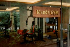 a sign for a manilla gym in a store at Fourteen Roses Boutique Hotel, Kuta in Legian