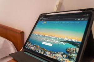 a laptop computer sitting on top of a table at Residence Tre Palme - Localo in Torre dell'Orso