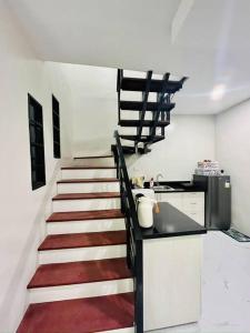 a staircase in a kitchen with a stair case at Modern Home in Lakeshore Mexico, Pampanga in Mexico