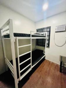 a bunk bed in a room with a fan at Modern Home in Lakeshore Mexico, Pampanga in Mexico