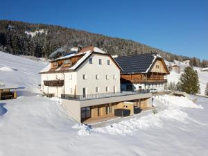 a large house in the snow in the snow at Rueper Hof Chalet Ruipa in Valdaora