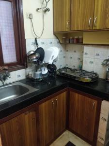 a kitchen with a sink and a counter top at Deer park Studio Flat (1 BHK) in New Delhi