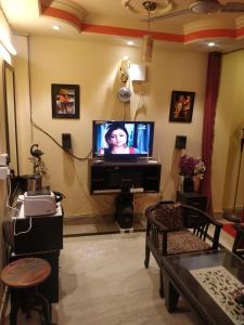 a living room with a flat screen tv at Deer park Studio Flat (1 BHK) in New Delhi