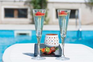 two champagne glasses with strawberries in them on a table at Vacation Home Mirasole in Mostar